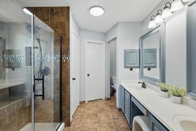 1010 Greenbriar Ln, Mckinney, TX 75069 - bathroom with toilet, a shower stall, double vanity, and stone finish flooring