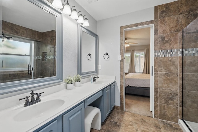 1010 Greenbriar Ln, Mckinney, TX 75069 - ensuite bathroom featuring tiled shower, stone finish flooring, double vanity, and ceiling fan
