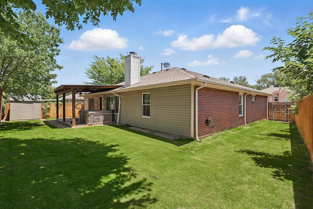 1010 Greenbriar Ln, Mckinney, TX 75069 - back of house with a hot tub, a chimney, brick siding, and roof with shingles