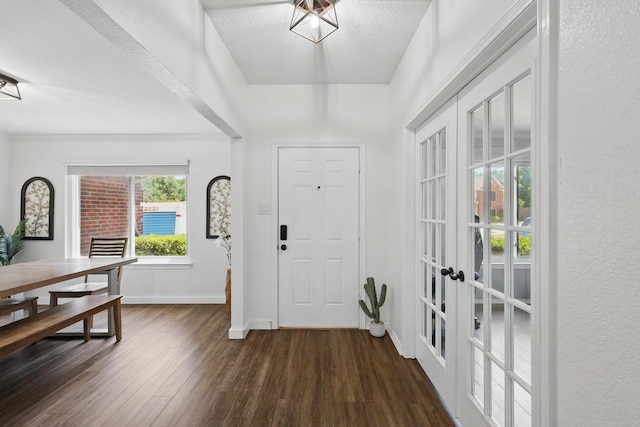 1010 Greenbriar Ln, Mckinney, TX 75069 - foyer entrance featuring dark wood finished floors, baseboards, french doors, and a textured ceiling