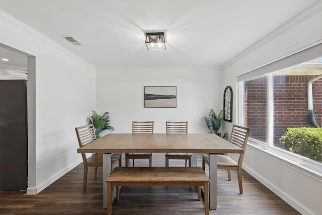 1010 Greenbriar Ln, Mckinney, TX 75069 - dining area featuring wood finished floors, baseboards, and crown molding