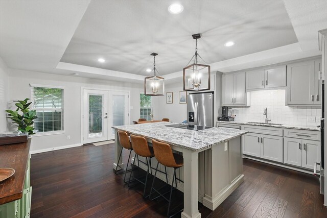 3713 Collinwood Ave, Fort Worth, TX 76107 - kitchen featuring stainless steel refrigerator with ice dispenser, a sink, a raised ceiling, light stone counters, and recessed lighting