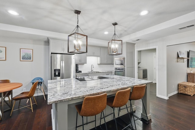 3713 Collinwood Ave, Fort Worth, TX 76107 - kitchen featuring appliances with stainless steel finishes, baseboards, washer / dryer, recessed lighting, and backsplash