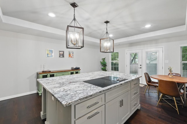 3713 Collinwood Ave, Fort Worth, TX 76107 - kitchen with black electric stovetop, a kitchen island, dark wood-style floors, recessed lighting, and french doors