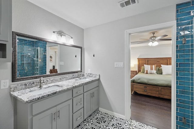 3713 Collinwood Ave, Fort Worth, TX 76107 - full bathroom featuring double vanity, connected bathroom, a shower stall, ceiling fan, and baseboards