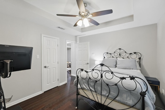 3713 Collinwood Ave, Fort Worth, TX 76107 - bedroom featuring a tray ceiling, hardwood / wood-style flooring, baseboards, and a ceiling fan