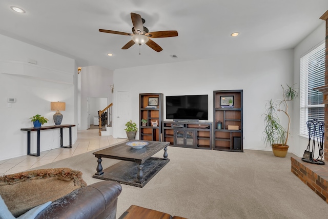 living area featuring a ceiling fan, recessed lighting, and stairs