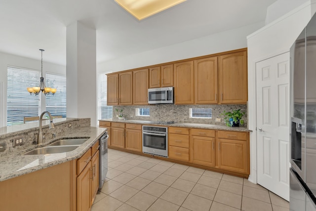 kitchen featuring stainless steel appliances, a sink, decorative backsplash, light tile patterned floors, and a chandelier