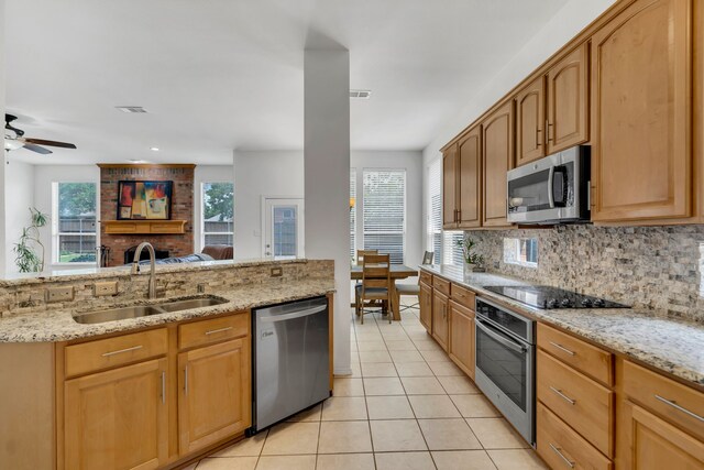 1804 Morning Mist Trl, Flower Mound, TX 75028 - kitchen with appliances with stainless steel finishes, light tile patterned floors, tasteful backsplash, light stone counters, and plenty of natural light
