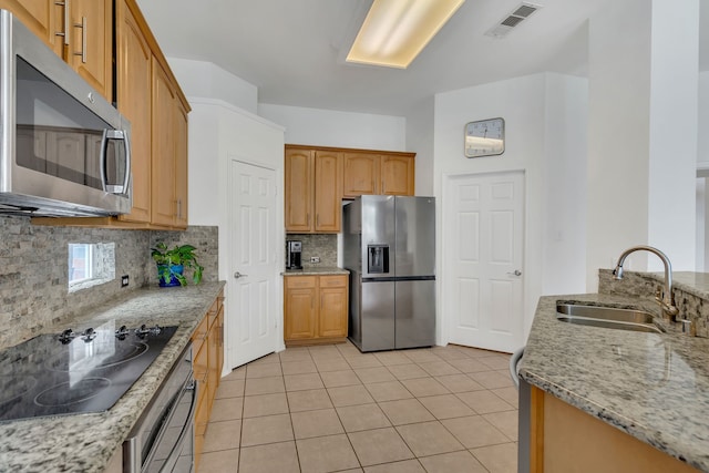 1804 Morning Mist Trl, Flower Mound, TX 75028 - kitchen with appliances with stainless steel finishes, decorative backsplash, light tile patterned floors, and light stone counters