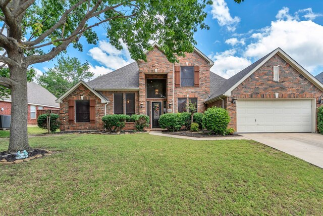 1804 Morning Mist Trl, Flower Mound, TX 75028 - traditional-style house featuring a front yard, driveway, an attached garage, and brick siding