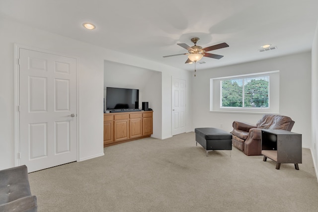 sitting room featuring light carpet, a ceiling fan, baseboards, and recessed lighting