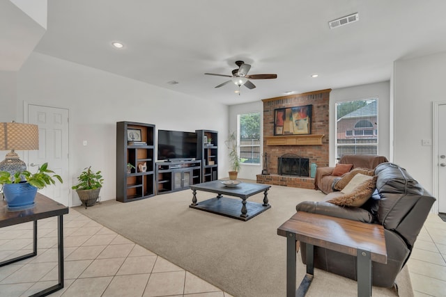 living area with light tile patterned floors, ceiling fan, a fireplace, recessed lighting, and light colored carpet