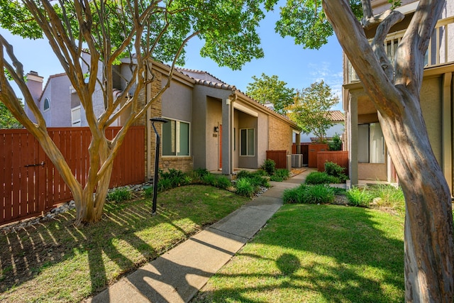 4242 N Capistrano Dr Unit 174, Dallas, TX 75287 - view of front of house featuring stucco siding, a tile roof, and central AC unit