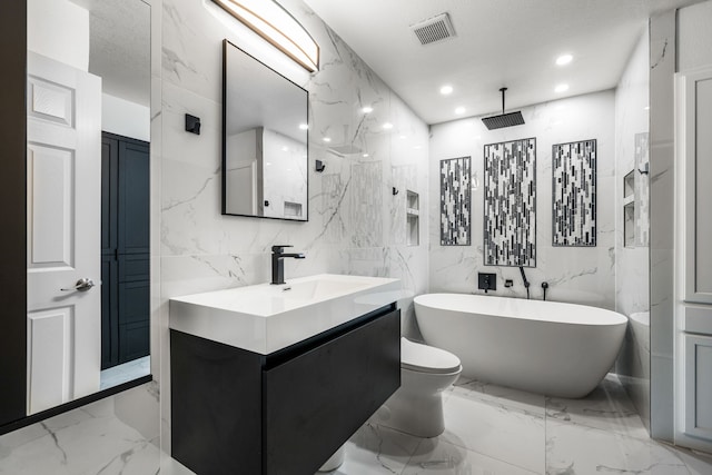 4242 N Capistrano Dr Unit 174, Dallas, TX 75287 - full bathroom featuring a freestanding bath, marble tiled floors, recessed lighting, vanity, and toilet