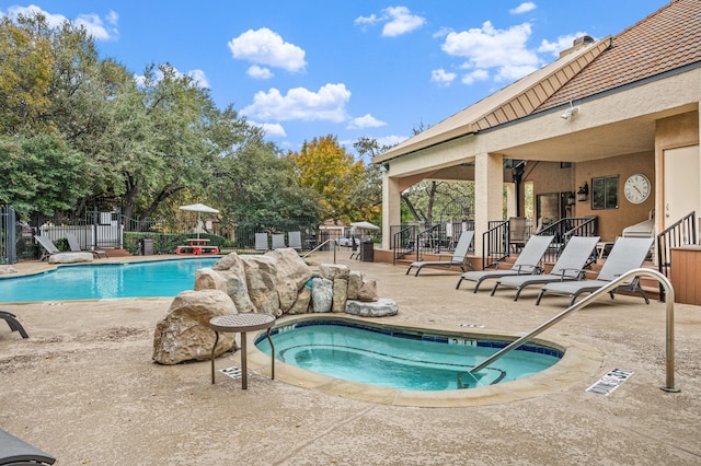 4242 N Capistrano Dr Unit 174, Dallas, TX 75287 - community pool with a patio area, fence, and a hot tub