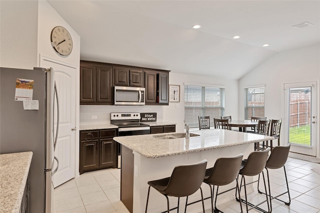 9220 Nevis Dr, Fort Worth, TX 76123 - kitchen with stainless steel appliances, a sink, light tile patterned floors, healthy amount of natural light, and lofted ceiling