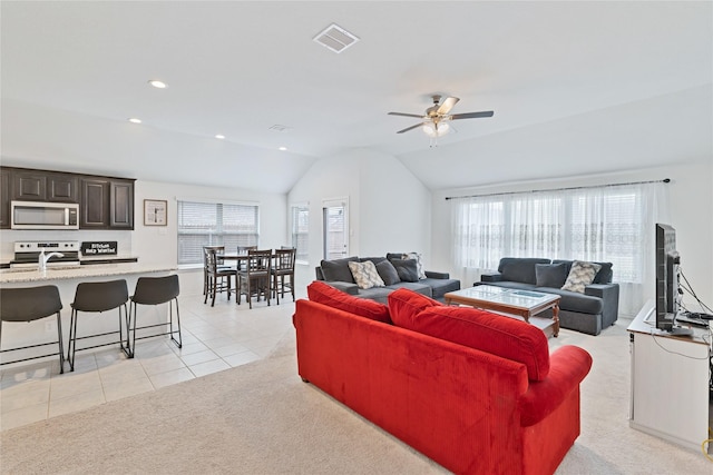 9220 Nevis Dr, Fort Worth, TX 76123 - living area featuring lofted ceiling, light tile patterned flooring, a ceiling fan, light carpet, and recessed lighting