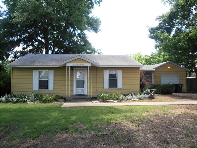 2108 Norwood Ln, Arlington, TX 76013 - view of front of property featuring a garage, a front lawn, and an outbuilding