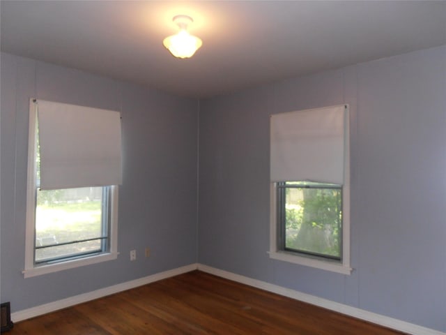 2108 Norwood Ln, Arlington, TX 76013 - empty room featuring dark wood-style flooring and baseboards