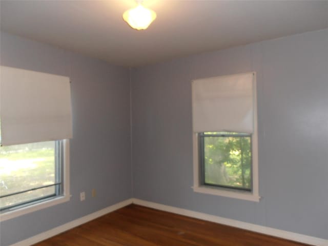 2108 Norwood Ln, Arlington, TX 76013 - empty room with dark wood finished floors and baseboards