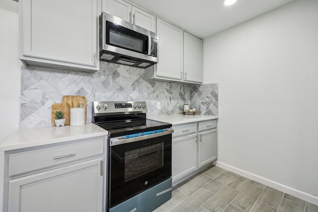 101 Oakmont Dr, Trophy Club, TX 76262 - kitchen featuring appliances with stainless steel finishes, backsplash, baseboards, and light countertops