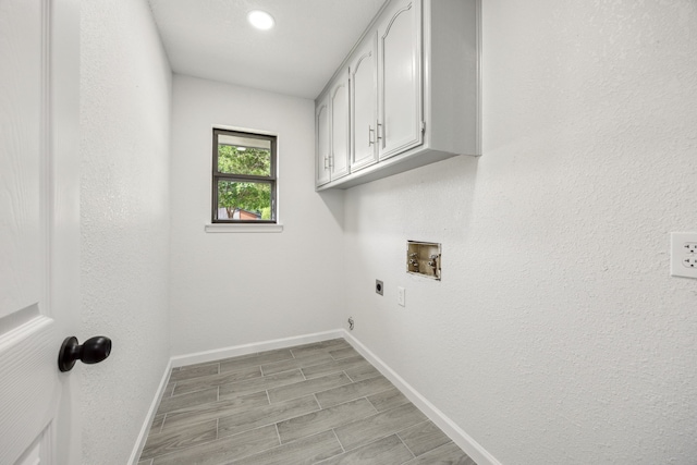 101 Oakmont Dr, Trophy Club, TX 76262 - laundry room featuring cabinet space, hookup for an electric dryer, hookup for a washing machine, baseboards, and wood tiled floors