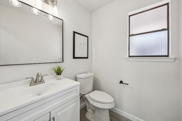 101 Oakmont Dr, Trophy Club, TX 76262 - half bathroom with toilet, baseboards, vanity, and wood finished floors