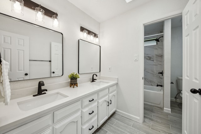 101 Oakmont Dr, Trophy Club, TX 76262 - full bathroom with double vanity, baseboards, shower / bathtub combination, wood finish floors, and toilet