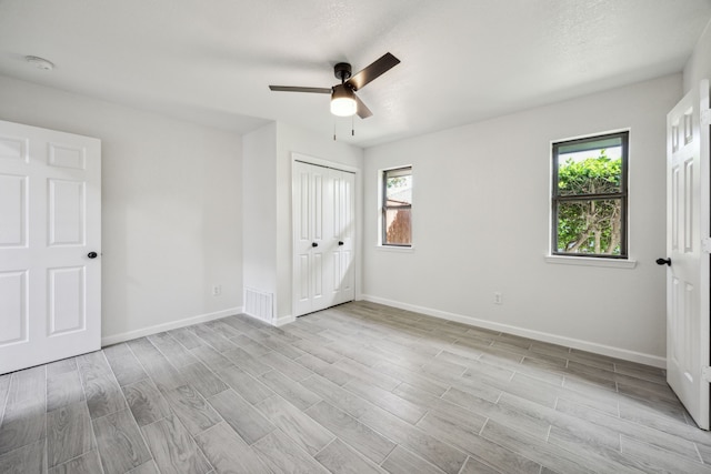 101 Oakmont Dr, Trophy Club, TX 76262 - unfurnished bedroom featuring multiple windows, baseboards, and light wood-style floors