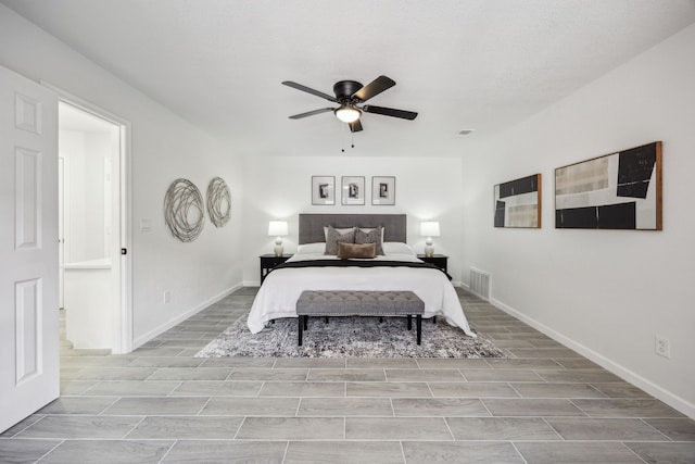 101 Oakmont Dr, Trophy Club, TX 76262 - bedroom with wood tiled floors, ceiling fan, and baseboards
