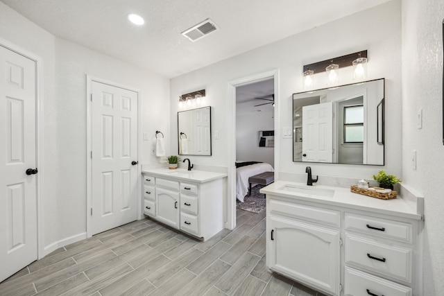 101 Oakmont Dr, Trophy Club, TX 76262 - ensuite bathroom with two vanities, wood finished floors, a ceiling fan, and recessed lighting