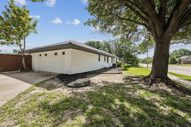101 Oakmont Dr, Trophy Club, TX 76262 - view of side of property with brick siding, central AC unit, and driveway