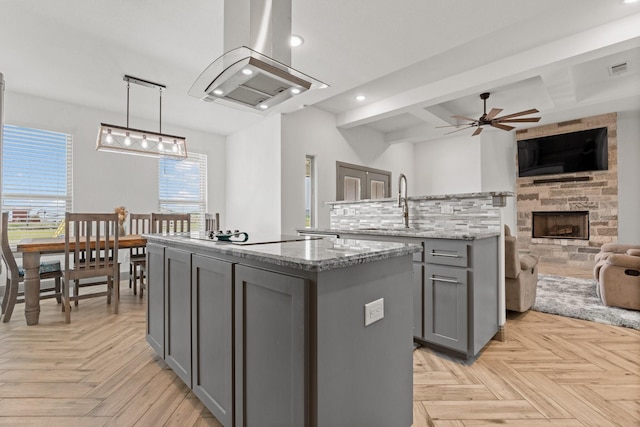 3304 Cobbler Ln, Joshua, TX 76058 - kitchen featuring gray cabinetry, a kitchen island with sink, extractor fan, open floor plan, and black electric cooktop
