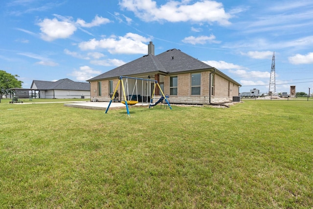 3304 Cobbler Ln, Joshua, TX 76058 - back of property with a playground, brick siding, a chimney, and a lawn