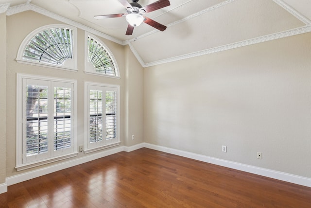 spare room with lofted ceiling, dark wood finished floors, a ceiling fan, baseboards, and ornamental molding