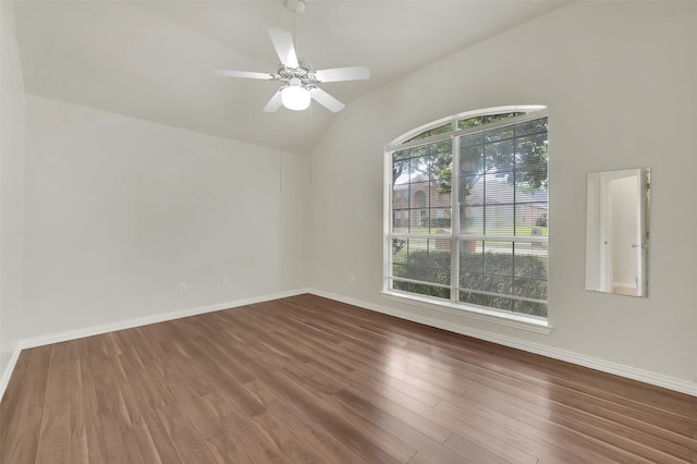 unfurnished room featuring wood finished floors, lofted ceiling, baseboards, and ceiling fan