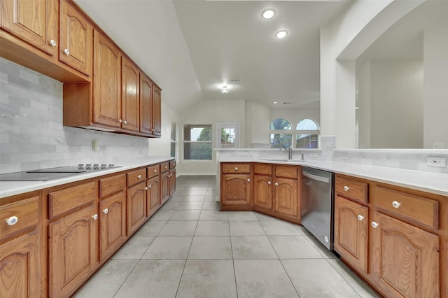 kitchen with stainless steel dishwasher, backsplash, vaulted ceiling, black electric cooktop, and a sink