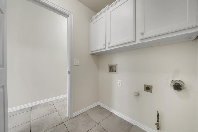 washroom with gas dryer hookup, hookup for an electric dryer, hookup for a washing machine, baseboards, and light tile patterned flooring