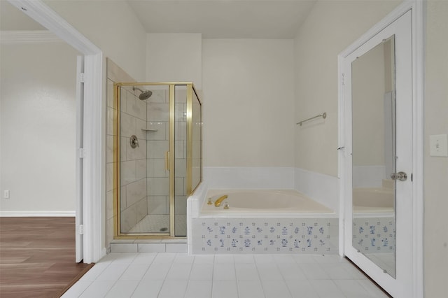 full bath featuring a stall shower and a garden tub