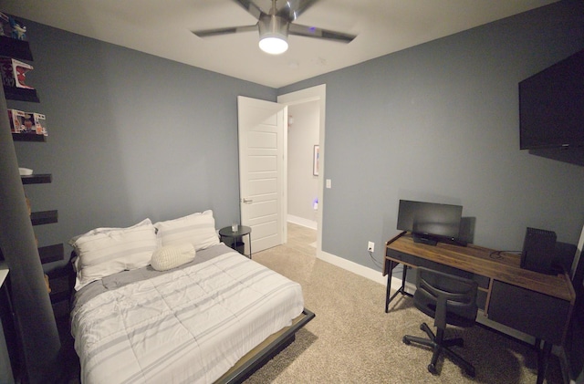 bedroom with light carpet, a desk, baseboards, and ceiling fan