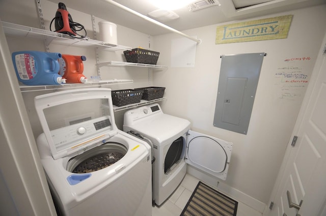 laundry room with electric panel, independent washer and dryer, baseboards, and light tile patterned floors