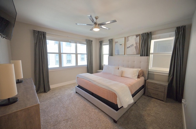 bedroom with carpet flooring, baseboards, and a ceiling fan