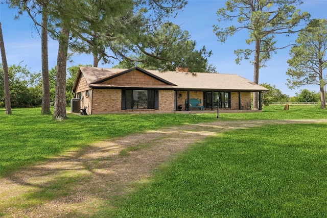 2173 Fairway Acres Dr, Argyle, TX 76226 - view of front of house featuring a front yard, central AC unit, and brick siding