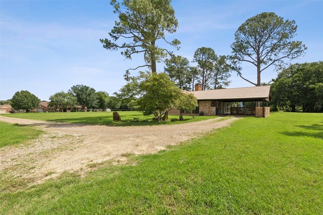 2173 Fairway Acres Dr, Argyle, TX 76226 - view of grassy yard featuring dirt driveway and a carport