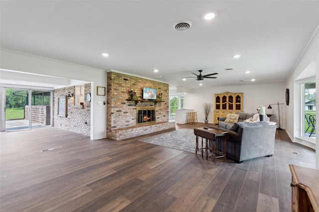 2173 Fairway Acres Dr, Argyle, TX 76226 - living room with a ceiling fan, dark wood-style flooring, a brick fireplace, ornamental molding, and recessed lighting