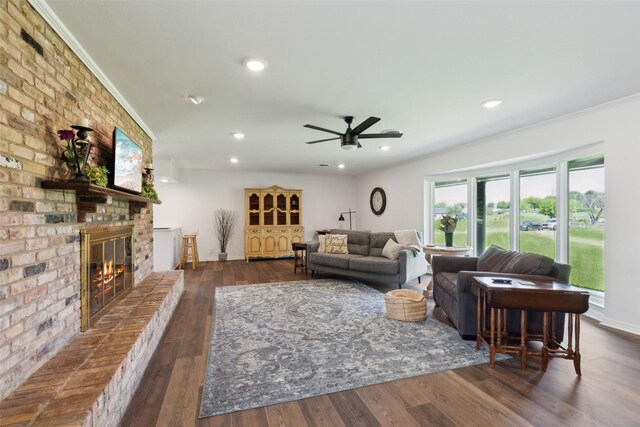 2173 Fairway Acres Dr, Argyle, TX 76226 - living area featuring a brick fireplace, wood finished floors, ornamental molding, ceiling fan, and baseboards