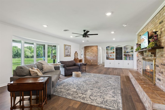 2173 Fairway Acres Dr, Argyle, TX 76226 - living area with arched walkways, hardwood / wood-style floors, crown molding, a brick fireplace, and a ceiling fan