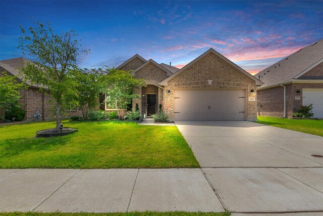 2125 Swanmore Way, Forney, TX 75126 - french country style house featuring brick siding, a garage, a front lawn, and concrete driveway