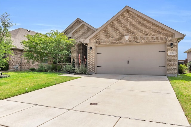 2125 Swanmore Way, Forney, TX 75126 - view of front of house with brick siding, a garage, a front yard, and driveway